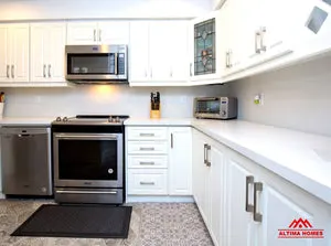 Small All-White Kitchen - Altima Homes Inc.