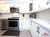 Small All-White Kitchen - Altima Homes Inc.