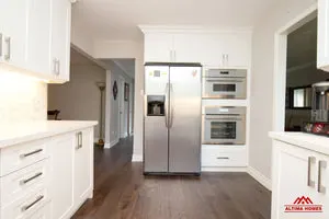 All-White Marble Blacksplash Kitchen - Altima Homes Inc.