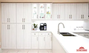 All-White Cabinets, Counter-tops and Floor Tiles Kitchen - Altima Homes Inc.