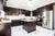 Large Kitchen with Brown Cabinets & White Quartz Counter - Altima Homes Inc.