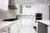 All-White Marble Floor Quartz Countertop Kitchen - Altima Homes Inc.